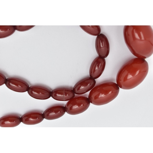 20 - A BAKELITE BEAD NECKLACE, comprising of thirty-five graduated oval shape beads measuring approximate... 