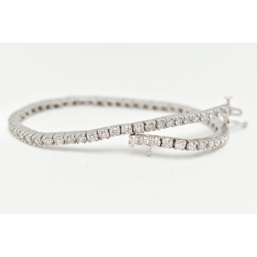 23 - A 9CT WHITE GOLD DIAMOND LINE BRACELET, designed as sixty-four round brilliant cut diamonds each wit... 