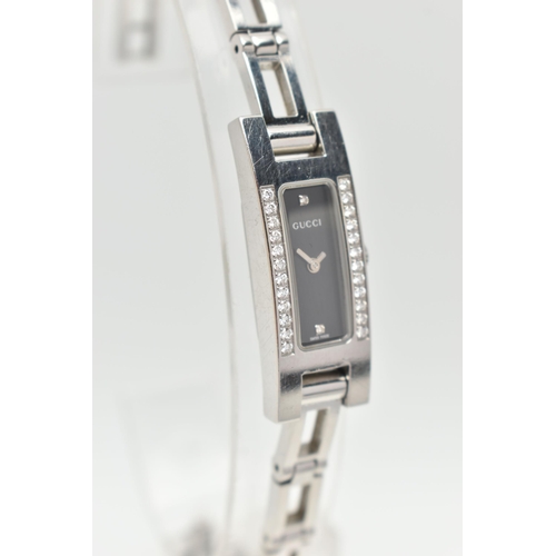 28 - A GUCCI DIAMOND SET WRISTWATCH, the black rectangular dial signed 'Gucci Swiss Made', diamond dot ma... 