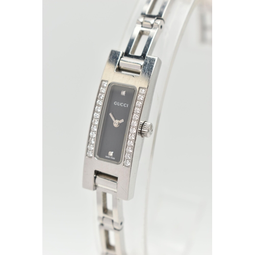 28 - A GUCCI DIAMOND SET WRISTWATCH, the black rectangular dial signed 'Gucci Swiss Made', diamond dot ma... 