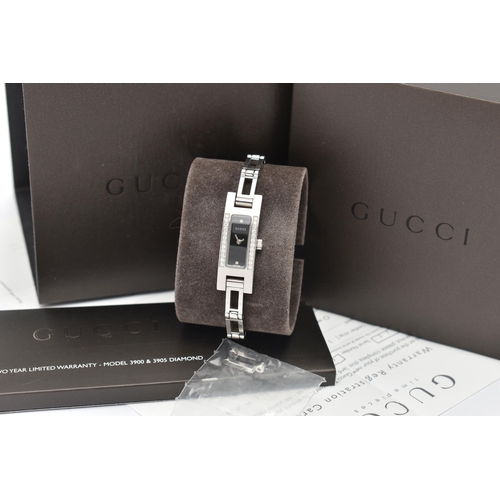 28 - A GUCCI DIAMOND SET WRISTWATCH, the black rectangular dial signed 'Gucci Swiss Made', diamond dot ma... 