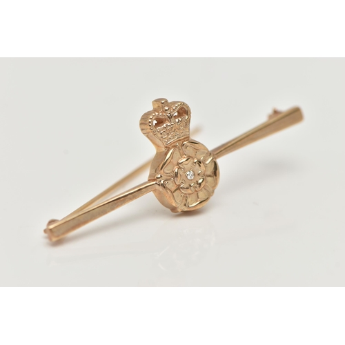 31 - A BOXED 9CT GOLD DIAMOND SET BROOCH, depicting a Tudor rose set with a small single cut diamond, dre... 