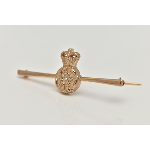 31 - A BOXED 9CT GOLD DIAMOND SET BROOCH, depicting a Tudor rose set with a small single cut diamond, dre... 