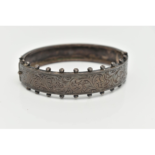 49 - A MID CENTURY SILVER BANGLE, a Victorian style hinged bangle with etched foliage detail and beading ... 