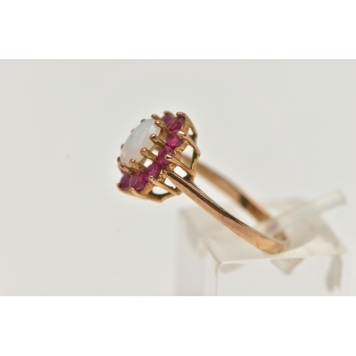 53 - A 9CT GOLD OPAL AND RUBY CLUSTER RING, the central oval opal cabochon within a circular cut ruby sur... 