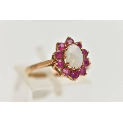 53 - A 9CT GOLD OPAL AND RUBY CLUSTER RING, the central oval opal cabochon within a circular cut ruby sur... 