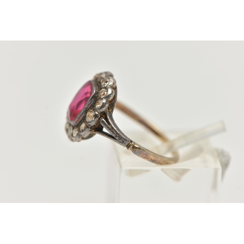 55 - AN EARLY 20TH CENTURY GEM SET RING, designed as a central rectangular ruby within an old cut diamond... 