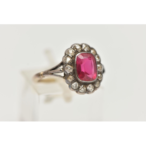 55 - AN EARLY 20TH CENTURY GEM SET RING, designed as a central rectangular ruby within an old cut diamond... 