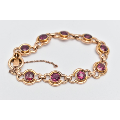 64 - A RHODOLITE GARNET LINE BRACELET, designed as a series of nine open work links, each set with a circ... 