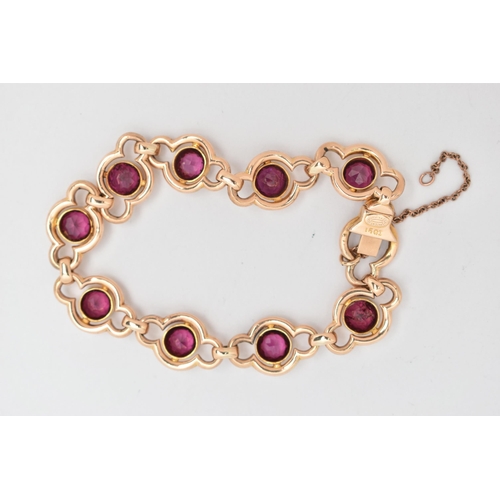 64 - A RHODOLITE GARNET LINE BRACELET, designed as a series of nine open work links, each set with a circ... 