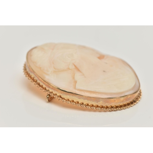 66 - A 9CT GOLD CAMEO BROOCH, of an oval outline, carved shell cameo depicting a lady in profile, milgrai... 