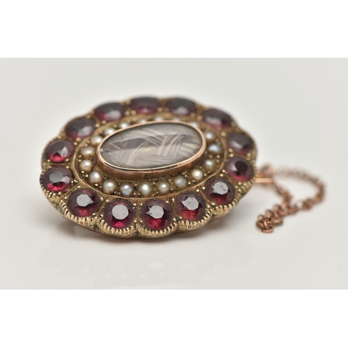 67 - A LATE VICTORIAN MOURNING BROOCH, of an oval outline, plaited hair centre piece with glazed panel, t... 