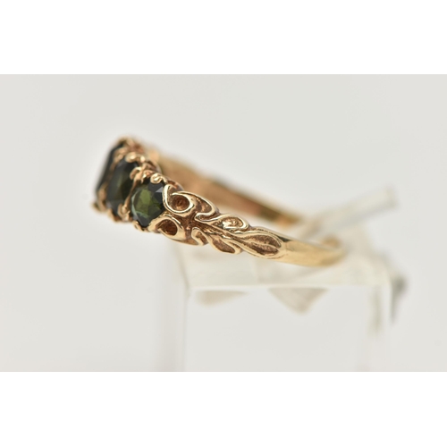 69 - A 9CT GOLD GREEN TOURMALINE RING, designed as a row of three oval cut tourmaline, and two circular c... 