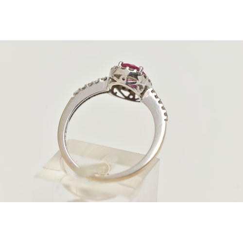 71 - AN 18CT WHITE GOLD RUBY AND DIAMOND RING, set with an oval cut ruby, in a halo of round brilliant cu... 