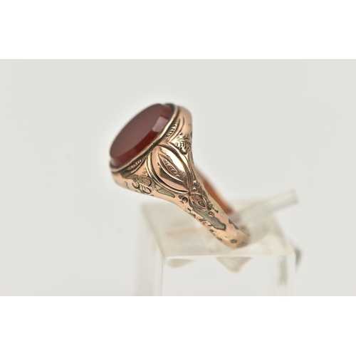 72 - A GENTS SIGNET RING, of an oval form, set with an oval carnelian panel, collet set to the textured s... 