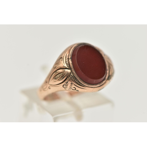 72 - A GENTS SIGNET RING, of an oval form, set with an oval carnelian panel, collet set to the textured s... 