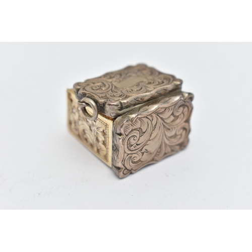 119 - A VICTORIAN SILVER VINAIGRETTE OF WAVY RECTANGULAR OUTLINE, foliate engraved decoration, vacant scro... 