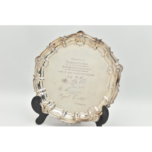 129 - AN ELIZABETH II SILVER SALVER WITH PRESENTATION INSCRIPTION, shell and scroll border, the centre eng... 