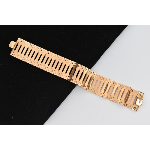 96 - A YELLOW METAL BRACELET, the wide link bracelet with plain polished rectangular links and flower acc... 