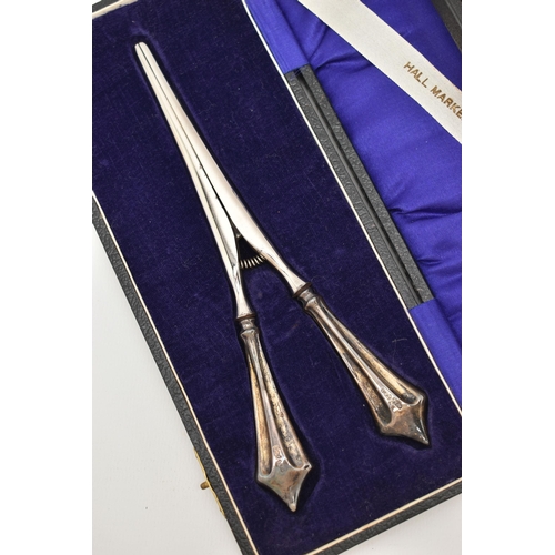 164 - CASED SILVER SPOONS AND GLOVE STRETCHERS, the pair of cased late Victorian silver spoons have shell ... 