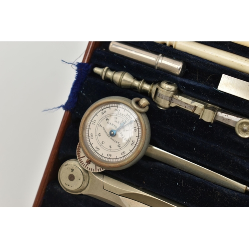 167 - A BOXED TECHNICAL DRAWING SET, with geometric drawing instruments, a folding wooden and brass ruler,... 