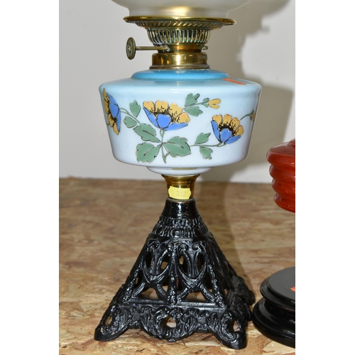 342 - THREE LARGE VICTORIAN OIL LAMPS, comprising a cast pyramid shaped lamp base, with a blue custard gla... 