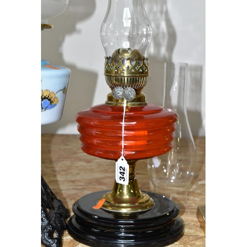 342 - THREE LARGE VICTORIAN OIL LAMPS, comprising a cast pyramid shaped lamp base, with a blue custard gla... 