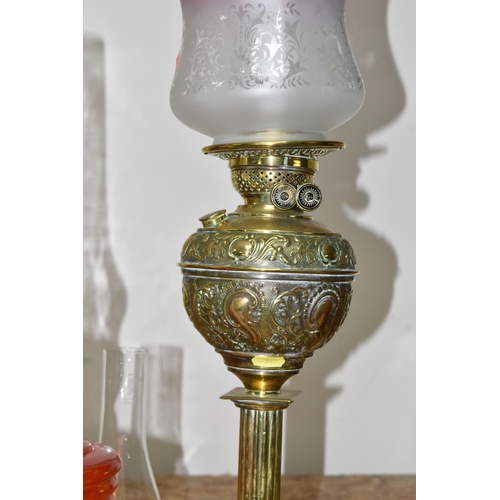 342 - THREE LARGE VICTORIAN OIL LAMPS, comprising a cast pyramid shaped lamp base, with a blue custard gla... 