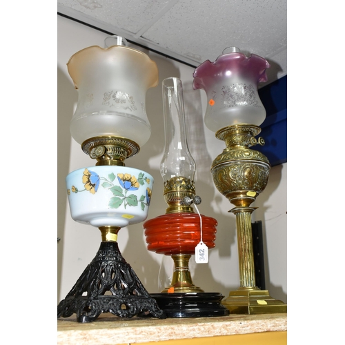 342 - THREE LARGE VICTORIAN OIL LAMPS, comprising a cast pyramid shaped lamp base, with a blue custard gla... 