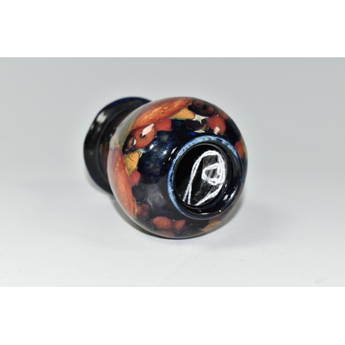 385 - A SMALL MOORCROFT POTTERY 'POMEGRANATE' BALUSTER VASE, with tube lined Pomegranate pattern on a navy... 