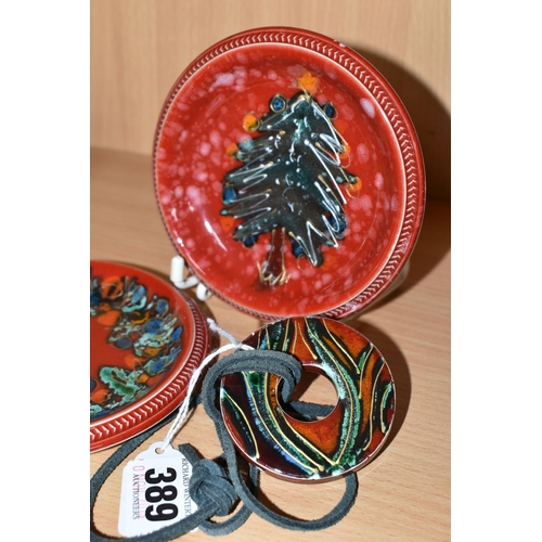 389 - THREE PIECES OF ANITA HARRIS POTTERY, comprising a pair of hand painted pin dishes with Christmas th... 