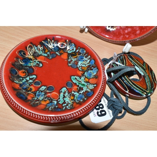 389 - THREE PIECES OF ANITA HARRIS POTTERY, comprising a pair of hand painted pin dishes with Christmas th... 