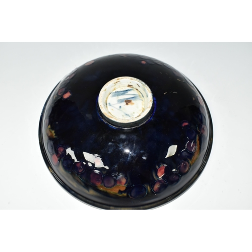 394 - A WILLIAM MOORCROFT SHALLOW FRUIT BOWL DECORATED WITH THE POMEGRANATE PATTERN ON A BLUE / BROWN GREE... 