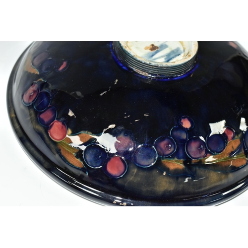 394 - A WILLIAM MOORCROFT SHALLOW FRUIT BOWL DECORATED WITH THE POMEGRANATE PATTERN ON A BLUE / BROWN GREE... 