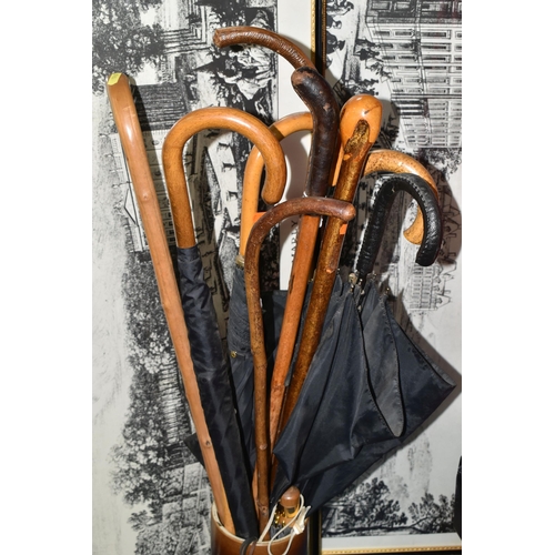 510 - A GROUP OF WALKING STICKS, UMBRELLAS AND FRAMED PRINTS, to include four walking sticks - one with a ... 