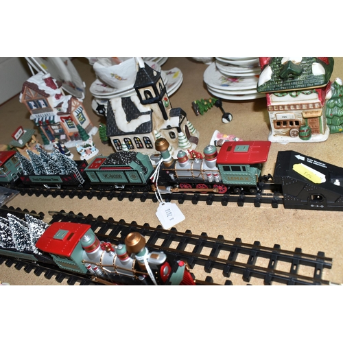 573 - TWO LEMAX CHRISTMAS VILLAGE TRAIN SETS AND WINTER BUILDINGS ETC, to include three churches, three in... 