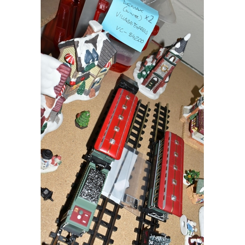 573 - TWO LEMAX CHRISTMAS VILLAGE TRAIN SETS AND WINTER BUILDINGS ETC, to include three churches, three in... 