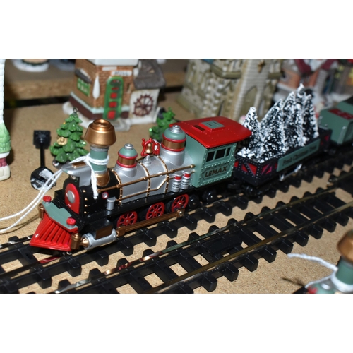 573 - TWO LEMAX CHRISTMAS VILLAGE TRAIN SETS AND WINTER BUILDINGS ETC, to include three churches, three in... 