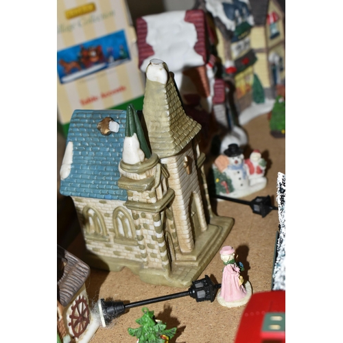 573 - TWO LEMAX CHRISTMAS VILLAGE TRAIN SETS AND WINTER BUILDINGS ETC, to include three churches, three in... 