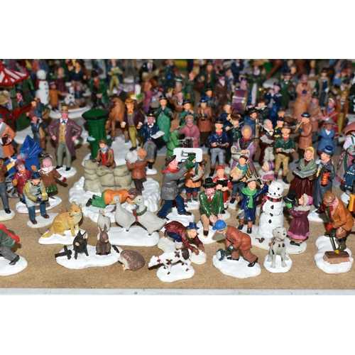 576 - A COLLECTION OF CHRISTMAS VILLAGE FIGURES, TREES AND OTHER ITEMS, to include over one hundred figure... 