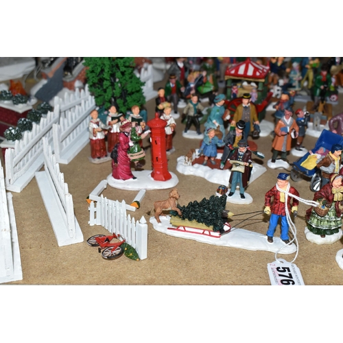 576 - A COLLECTION OF CHRISTMAS VILLAGE FIGURES, TREES AND OTHER ITEMS, to include over one hundred figure... 