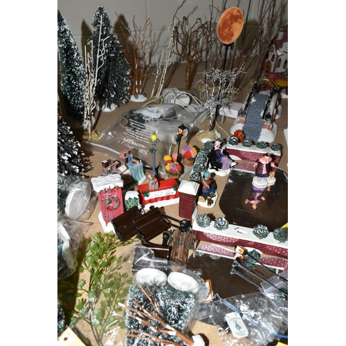 576 - A COLLECTION OF CHRISTMAS VILLAGE FIGURES, TREES AND OTHER ITEMS, to include over one hundred figure... 