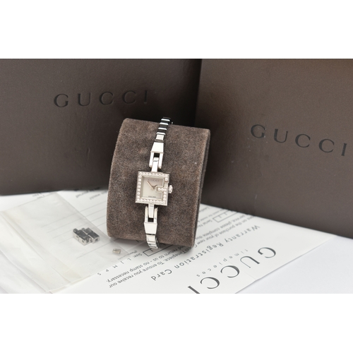 29 - A GUCCI DIAMOND SET WRISTWATCH, the mother of pearl square dial, signed 'Gucci Swiss Made', square c... 