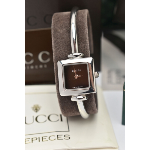 27 - TWO GUCCI WATCHES, to include a wristwatch with a black square dial, the dial is signed 'GUCCI Swiss... 