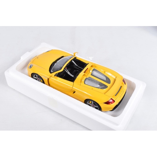 110 - A BOXED AUTOART MILLENIUM 1:18 SCALE PORSCHE CARRERA GT DIECAST MODEL VEHCLE, numbered 78043, in yel... 