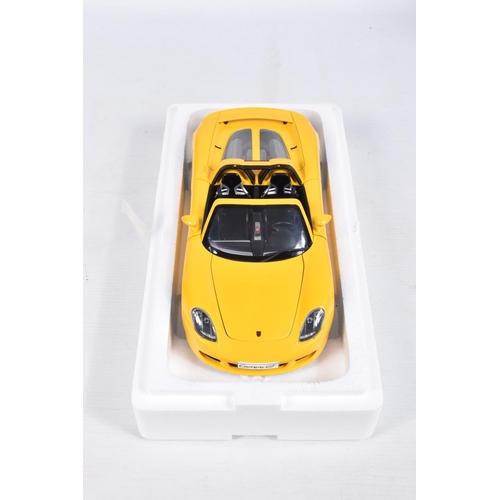 110 - A BOXED AUTOART MILLENIUM 1:18 SCALE PORSCHE CARRERA GT DIECAST MODEL VEHCLE, numbered 78043, in yel... 