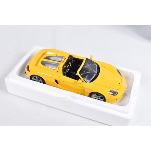 110 - A BOXED AUTOART MILLENIUM 1:18 SCALE PORSCHE CARRERA GT DIECAST MODEL VEHCLE, numbered 78043, in yel... 