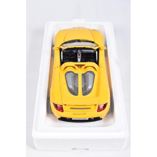 110 - A BOXED AUTOART MILLENIUM 1:18 SCALE PORSCHE CARRERA GT DIECAST MODEL VEHCLE, numbered 78043, in yel... 