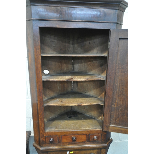 1206 - A GEORGIAN OAK CORNER CUPBOARD, with a single cupboard door above a single drawer and two dummy draw... 