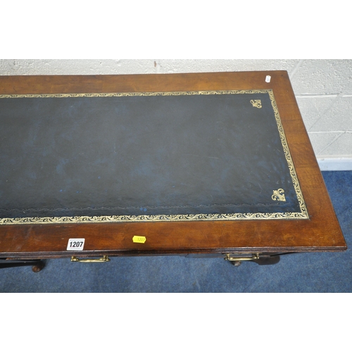 1207 - A 20TH CENTURY MAHOGANY KNEE HOLE DESK, with blue tooled leather writing surface, fitted with three ... 